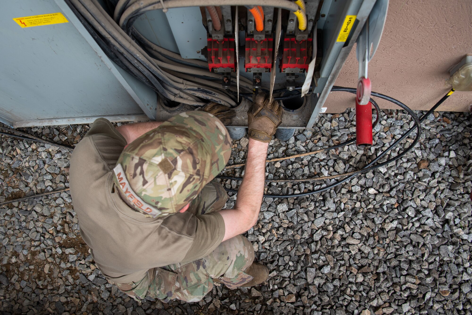 Master Sgt. Kenneth Mayfield, 51st Civil Engineer Squadron NCO in charge of electrical power production, connects Seoraksan Tower wires to an alternate power source at Osan Air Base, Republic of Korea, April 21, 2022.