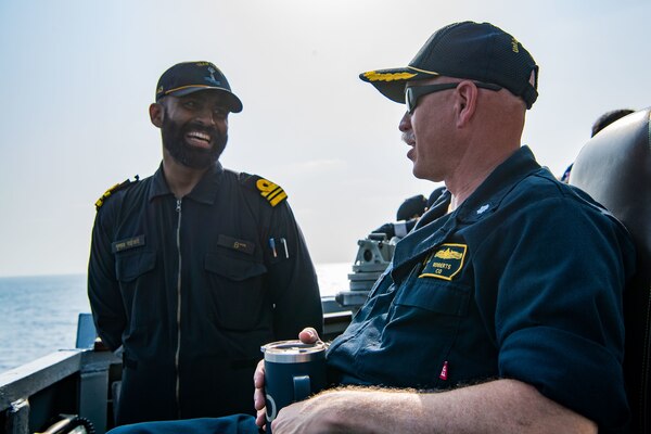 220427-N-TT059-1196 ARABIAN SEA (Apr. 27, 2022) Cmdr. Erik Roberts, commanding officer of the Arleigh Burke-class guided-missile destroyer USS Momsen (DDG 92), speaks to sailors of the Indian Navy during a bilateral training exercise with the Indian Navy's guided-missile frigate INS Trishul (F 43). USS Momsen is assigned to Commander, Task Force 71/Destroyer Squadron (DESRON) 15, the Navy's largest forward-deployed DESRON and the U.S. 7th Fleet's principal surface force, and is underway supporting a free and open Indo-Pacific. (U.S. Navy photo by Mass Communication Specialist 3rd Class Lily Gebauer)