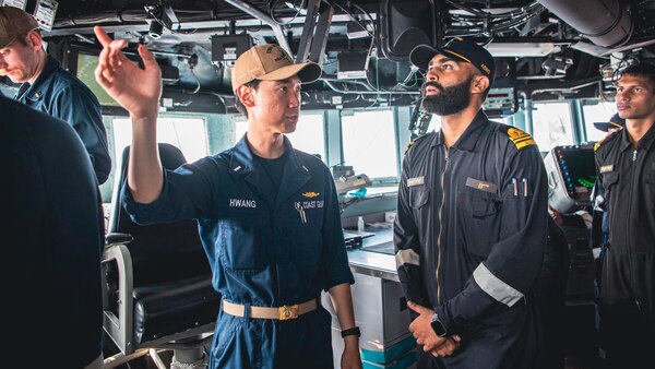 220427-N-TT059-1117 ARABIAN SEA (Apr. 27, 2022) Lt. j.g. Seung Hwang describes the functions of the pilot house to sailors of the Indian Navy aboard Arleigh Burke-class guided-missile destroyer USS Momsen (DDG 92) during a bilateral training exercise with the Indian Navy's guided-missile frigate INS Trishul (F 43). USS Momsen is assigned to Commander, Task Force 71/Destroyer Squadron (DESRON) 15, the Navy's largest forward-deployed DESRON and the U.S. 7th Fleet's principal surface force, and is underway supporting a free and open Indo-Pacific. (U.S. Navy photo by Mass Communication Specialist 3rd Class Lily Gebauer)