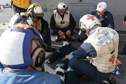 220427-N-UN585-1004 MEDITERRANEAN SEA (April 27, 2022) Sailors assigned to the Arleigh Burke-class guided-missile destroyer USS Ross (DDG 71) treat a simulated injury during an aircraft crash drill aboard the ship, April 27, 2022. Ross, forward-deployed to Rota, Spain, is on its 12th patrol in the U.S. Sixth Fleet area of operations in support of regional allies and partners and U.S. national security interests in Europe and Africa. (U.S. Navy photo by Mass Communication Specialist 2nd Class Claire DuBois/Released)