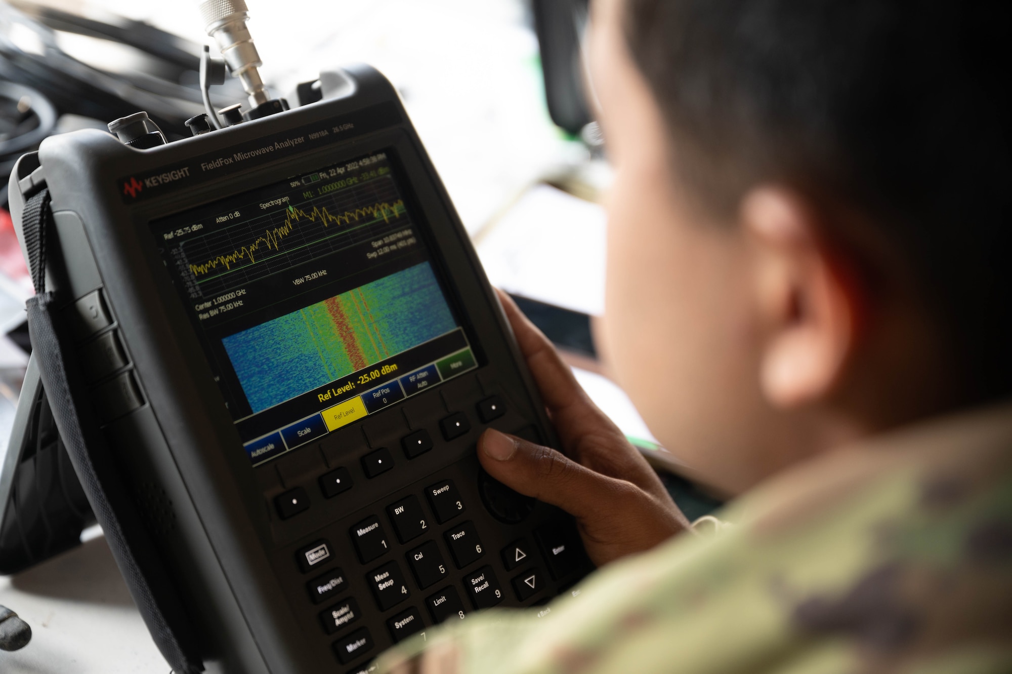 U.S. Army soldier uses devices to receive satellite transmissions.