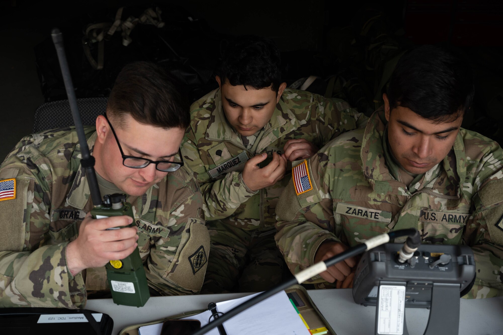 U.S. Army soldiers analyze satellite transmissions.