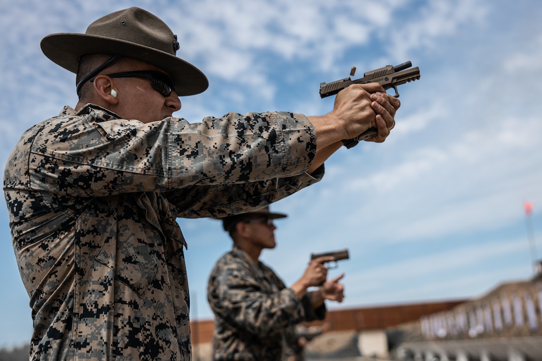 U.S. Marine Corps Staff Sgt. Marco Casillas, an instructor for Formal Marksmanship Training Center, Weapons and Field Training Battalion, demonstrates a drill during block three of the Combat Pistol Program, at Camp Pendleton, Calif., April 26. Table one of CPP consists of 5 training blocks and 200 rounds per Marine.