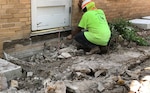 A historically qualified mason reconstructs a section of Building 1’s exterior wall using brick salvaged from a section of the foundation that could not be preserved at Camp Mabry, Texas. Enough original brick was salvaged so that no new brick was needed for repairs.