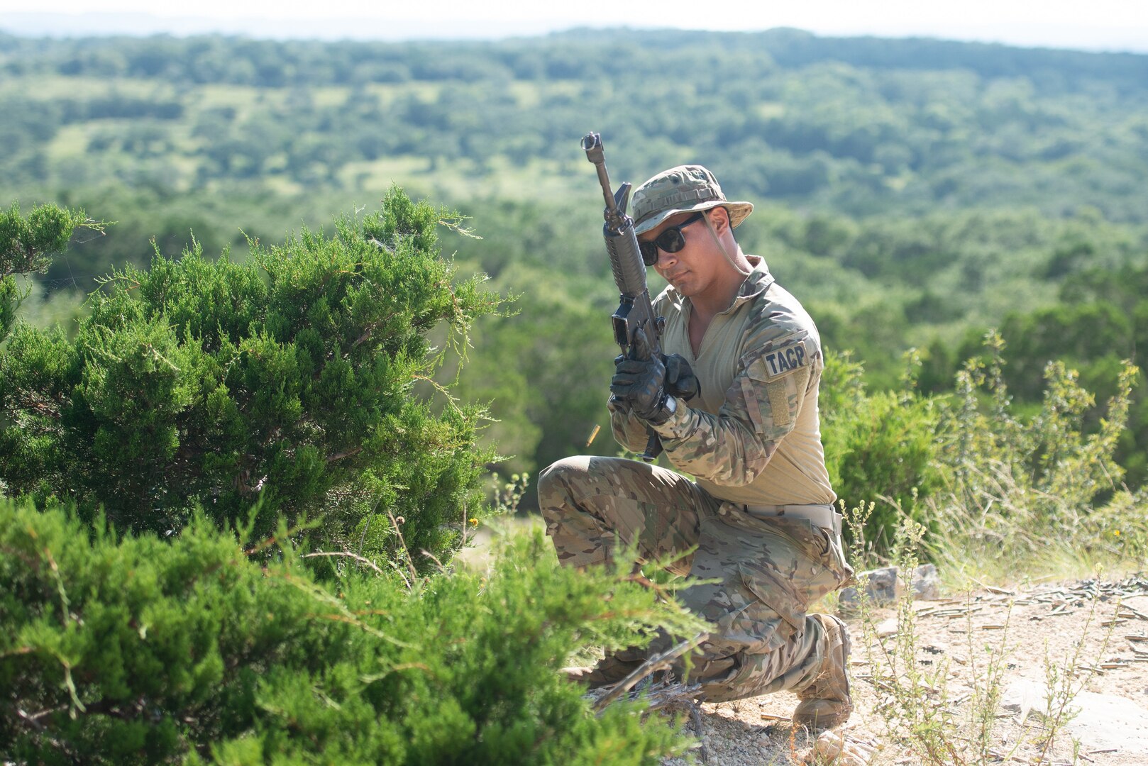 Airman with weapon on a hill.