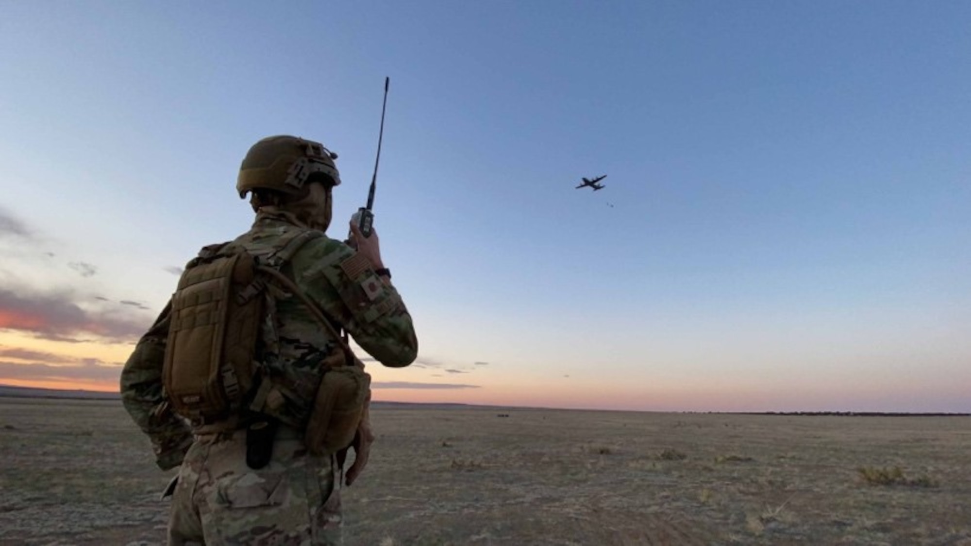 U.S. Air Force Maj. Jacob Hiles, an Air Mobility Liaison Officer Qualification Course student, controls the drop zone for a C-130 Hercules equipment drop, at Piñon Canyon Maneuver Site, Colo. The course trains 10-15 AMLO twice a year. There are a currently a little more than 55 AMLO actively stationed across the globe. (courtesy photo)