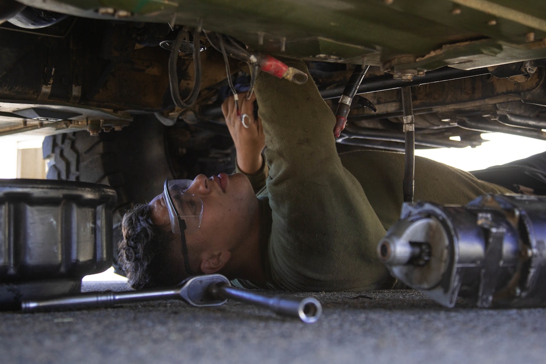U.S. Marine Corps Lance Cpl. Joshua Dorito, a motor transportation mechanic and Colten, California native with 1st Maintenance Battalion, 1st Marine Logistics Group, I Marine Expeditionary Force, works on a Humvee for the 11th Marines at Camp Pendleton, California, Nov. 4, 2021. A maintenance support team consists of a group of Marine-mechanics who are sent to different units to enhance the unit’s combat readiness by repairing military vehicles and equipment. (U.S. Marine Corps photo by Lance Cpl. Kristy Ordonez Maldonado)