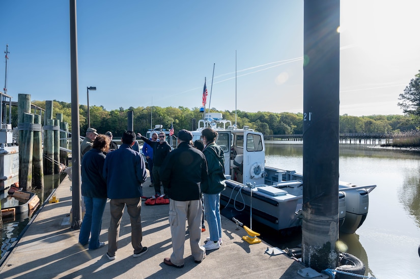 Individuals receive a brief before a boat ride.