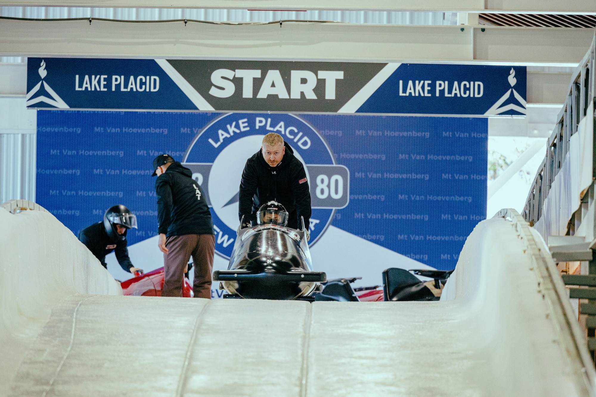 Tech. Sgt. Michael Bradley, 301st Airlift Squadron, Travis AFB, pushes his daughter Emily off at the start her run on the bobsled track. He is sharing the dream with his daughter Emily as she follows in his footsteps as a competitive bobsledder. Bradley has an impressive record as a professional bobsledder representing the U.S. Air Force.