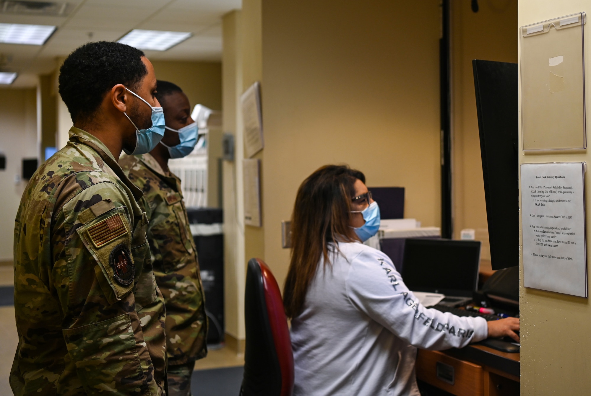 The 30th Medical Group Diagnostic and Therapeutics Flight works at the pharmacy window at Vandenberg Space Force Base, Calif., April 13, 2022. SrA Torren Farg, pharmacy technician (far left) and pharmacy front line supervisor works with TSgt. Willie Denson, Pharmacy NCOIC (middle), assisted Ms. Sherry Harney, civilian pharmacy technician (far right), with a customer that picked up their prescriptions. (U.S. Space Force photo by Airman 1st Class Tiarra Sibley)