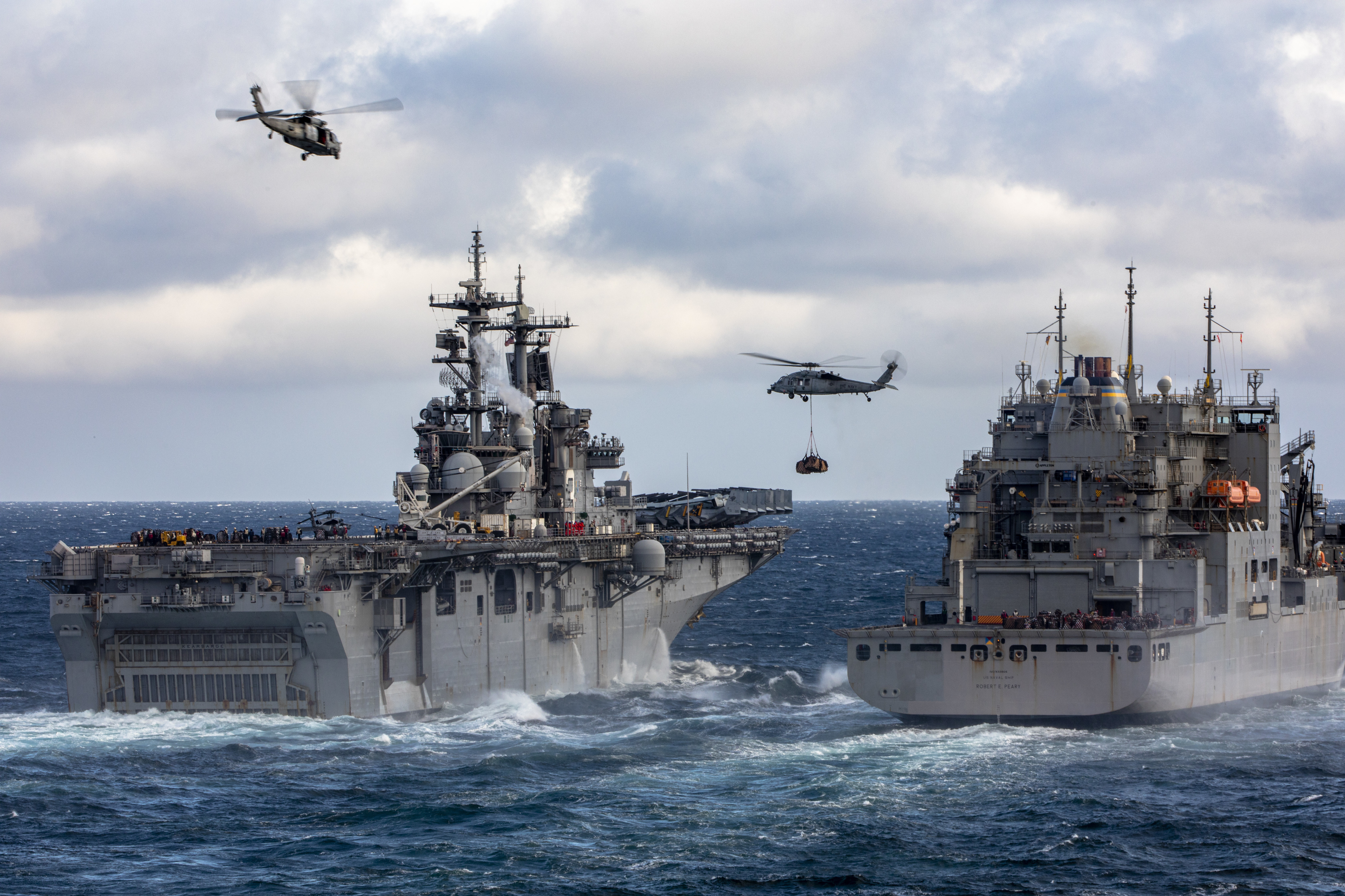 USS Kearsarge (LHD-3) and USNS Robert E. Peary (T-AKE 5) conduct a vertical replenishment in the Atlantic Ocean.