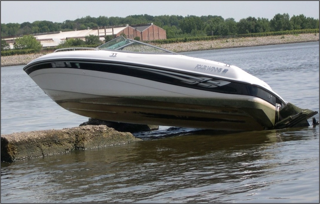 A boat sits on a lateral wall in the Mississippi River near Moline, Illinois, after a boating accident.