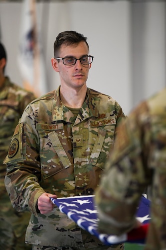 Senior Airman Steven Elgowsky, 445th Civil Engineer Squadron engineering aide and member of the Wright-Patterson Air Force Base Honor Guard, practices folding a flag during ceremonial guardsman training March 16. (U.S. Air Force photo by Master Sgt. Patrick O’Reilly)