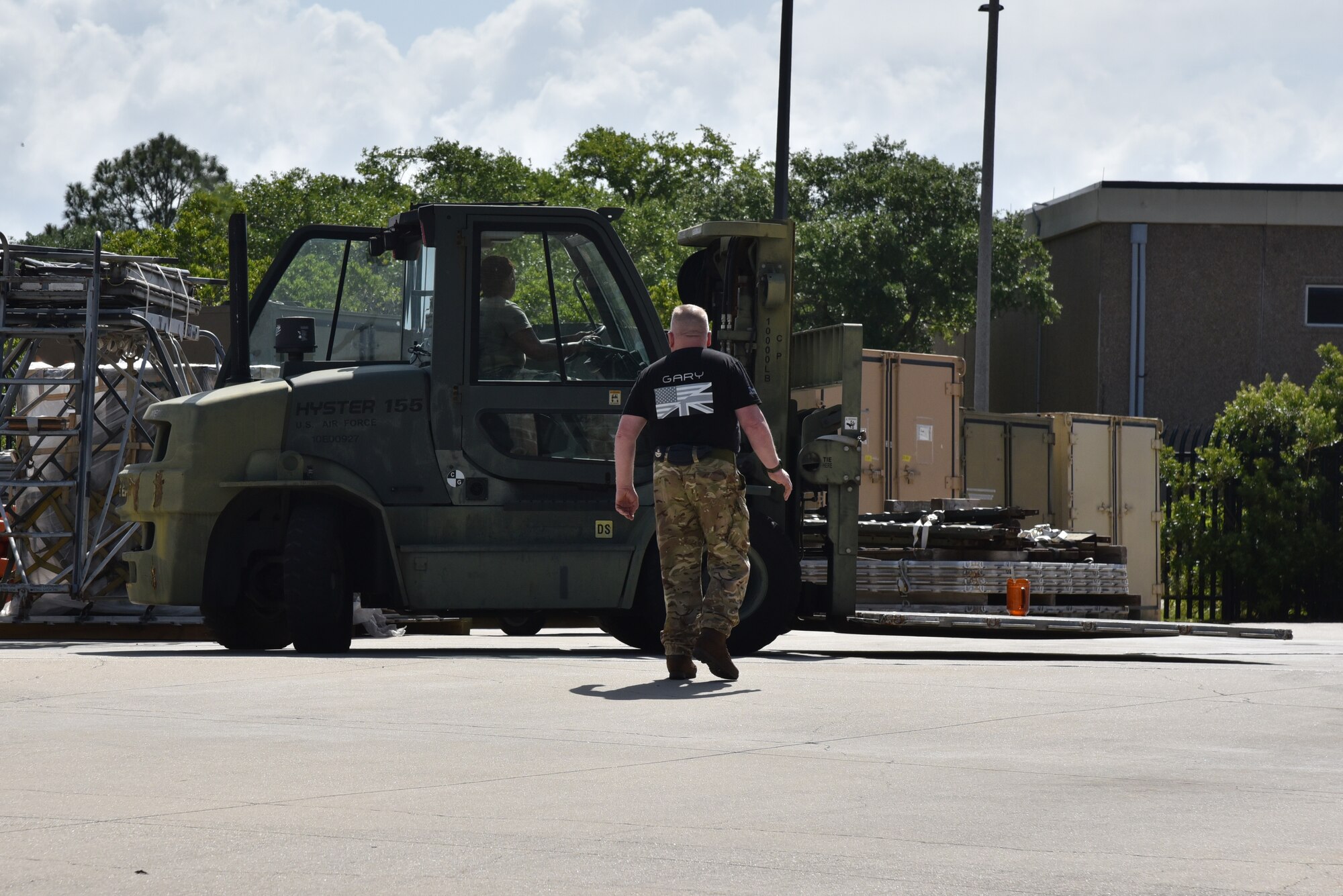 10K standard forklift driven by through cones by Air Force Reserve member being spotted by British Royal Air Force Reserve member.