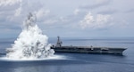 Photoshopped image of The aircraft carrier USS Gerald R. Ford (CVN 78) successfully completes the third and final scheduled explosive event for Full Ship Shock Trials while underway in the Atlantic Ocean, Aug. 8, 2021. The U.S. Navy conducts shock trials of new ship designs using live explosives to confirm that our warships can continue to meet demanding mission requirements under harsh conditions they may encounter in battle. (U.S. Navy Photo by Mass Communication Specialist 3rd Class Jackson Adkins)