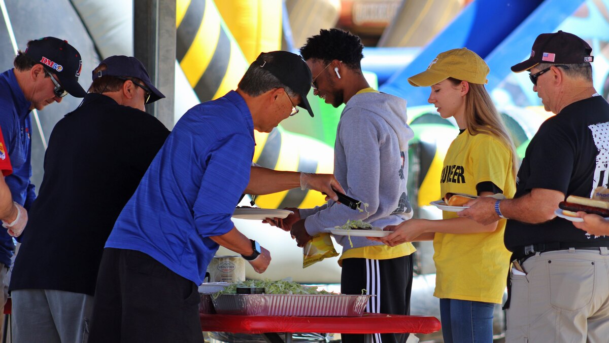 A photo of people getting food.