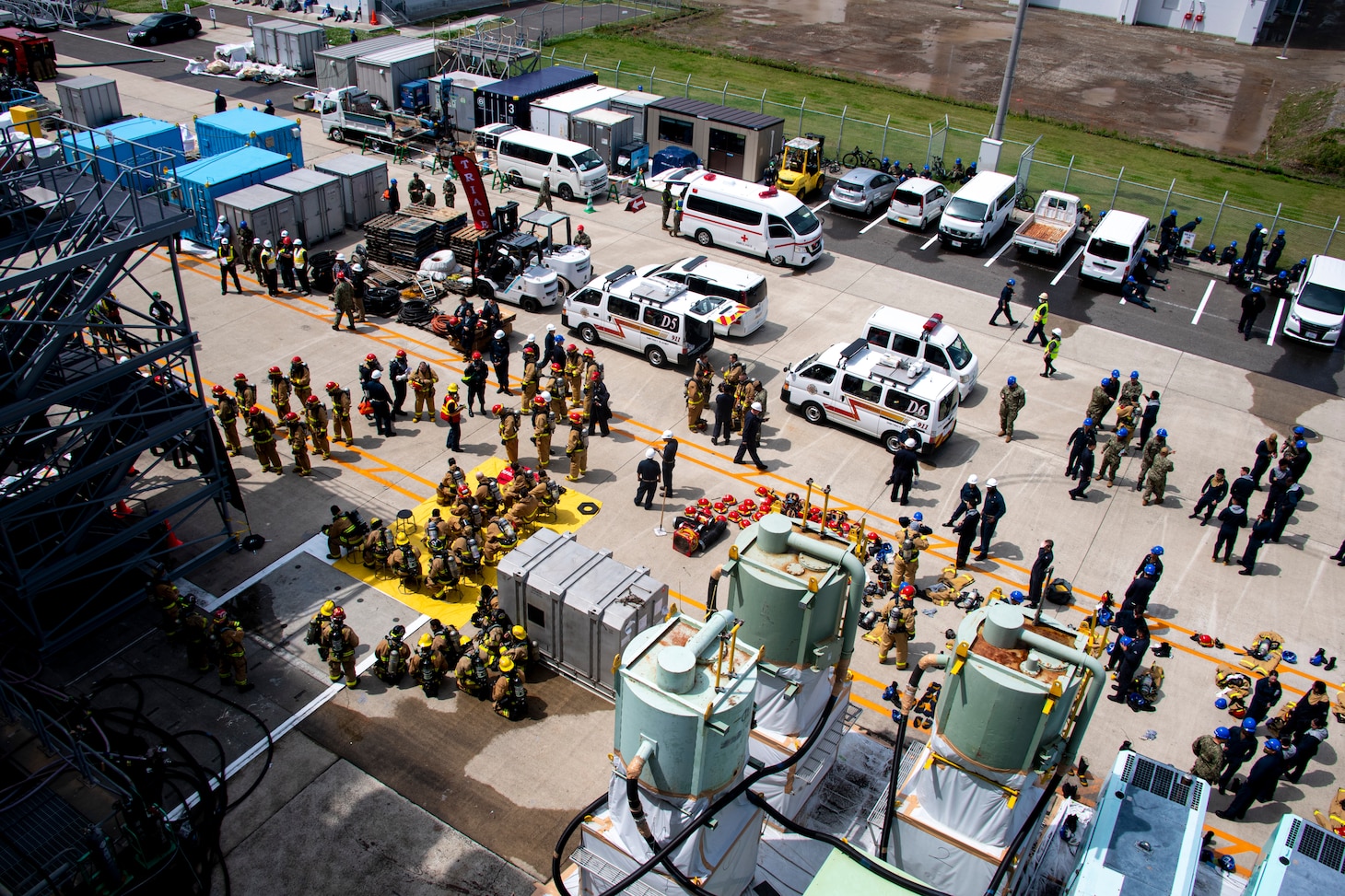 Sailors assigned to the forward-deployed amphibious assault ship USS America (LHA 6) conduct an integrated industrial firefighting drill with Commander, Naval Region Japan Fire & Emergency Services firefighters onboard U.S. Fleet Activities Sasebo, April 27. The drill, required by the Industrial Ship Safety Manual for Fire Prevention (8010), was created to train integrated teams of Sailors and base firefighters to casualties in industrial environments. America, lead ship of the America Amphibious Ready Group, is operating in the U.S. 7th Fleet area of responsibility to enhance interoperability with allies and partners and serve as a ready response force to defend peace and stability in the Indo-Pacific region. (U.S. Navy photo by Mass Communication Specialist Seamen Cole Pursley)