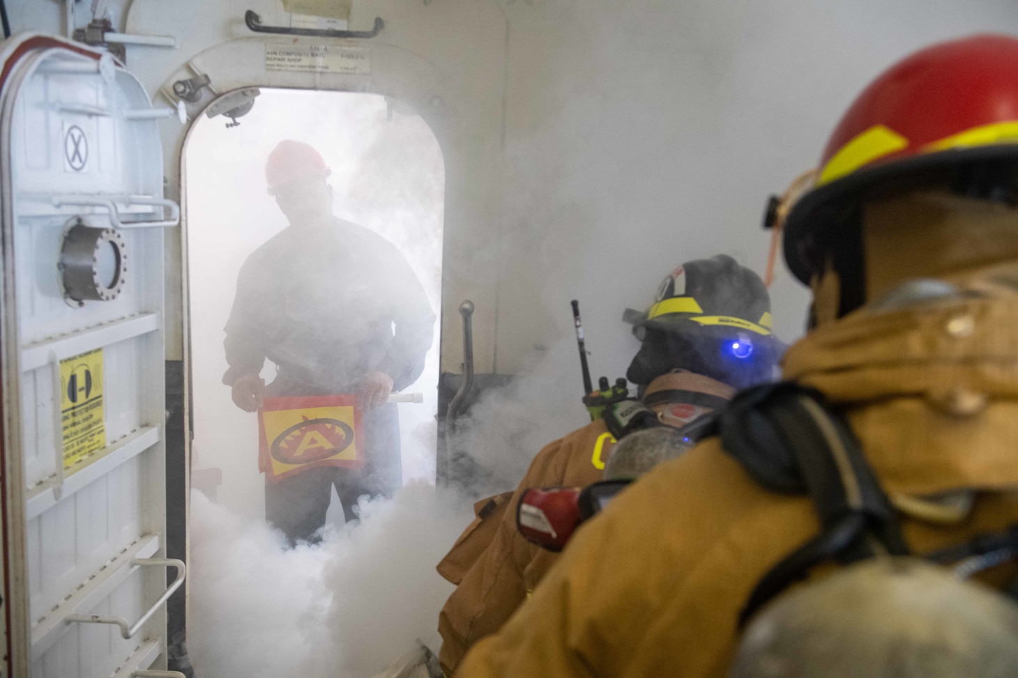 Sailors assigned to the forward-deployed amphibious assault ship USS America (LHA 6) engage a simulated fire in the ship’s hangar bay during an integrated industrial firefighting drill with Commander, Naval Region Japan Fire & Emergency Services firefighters onboard U.S. Fleet Activities Sasebo, April 27. The drill, required by the Industrial Ship Safety Manual for Fire Prevention (8010), was created to train integrated teams of Sailors and base firefighters to casualties in industrial environments. America, lead ship of the America Amphibious Ready Group, is operating in the U.S. 7th Fleet area of responsibility to enhance interoperability with allies and partners and serve as a ready response force to defend peace and stability in the Indo-Pacific region. (U.S. Navy photo by Mass Communication Specialist 3rd Class Matthew Cavenaile)