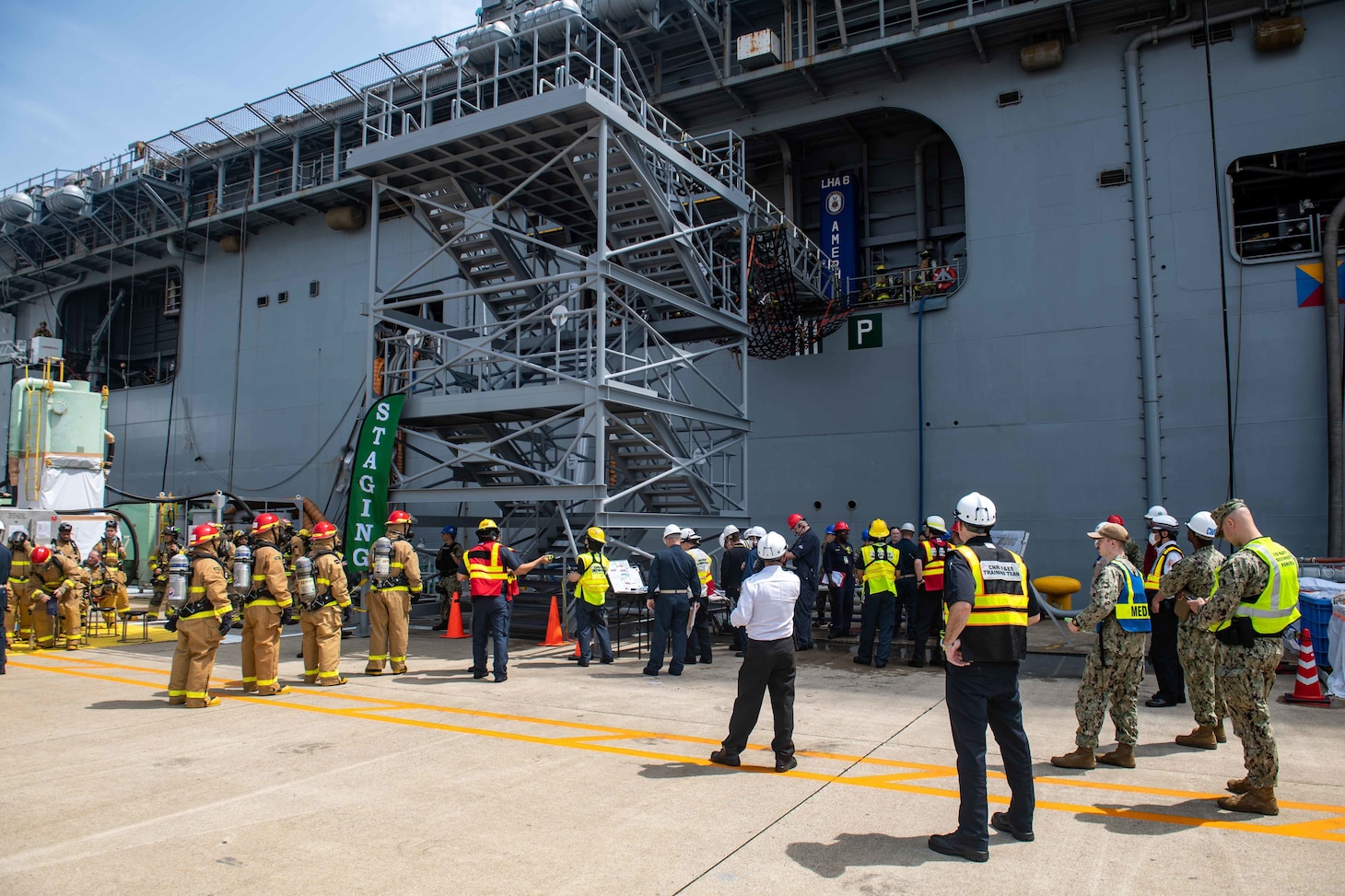 SASEBO, Japan (April 27, 2022) Sailors assigned to the forward-deployed amphibious assault ship USS America (LHA 6) conduct an integrated industrial firefighting drill with Commander, Naval Region Japan Fire & Emergency Services firefighters onboard U.S. Fleet Activities Sasebo, April 27. The drill, required by the Industrial Ship Safety Manual for Fire Prevention (8010), was created to train integrated teams of Sailors and base firefighters to casualties in industrial environments. America, lead ship of the America Amphibious Ready Group, is operating in the U.S. 7th Fleet area of responsibility to enhance interoperability with allies and partners and serve as a ready response force to defend peace and stability in the Indo-Pacific region. (U.S. Navy photo by Mass Communication Specialist 3rd Class Matthew Cavenaile)