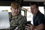 U.S. Navy Rear Adm. Douglas Sasse, Reserve Vice Commander, U.S. 4th Fleet, left, tests future operating concepts with a scientist from Naval Information Warfare Center Atlantic during a fleet experimentation period with various research and development agencies and U.S. Naval Forces Southern Command/U.S. 4th Fleet.