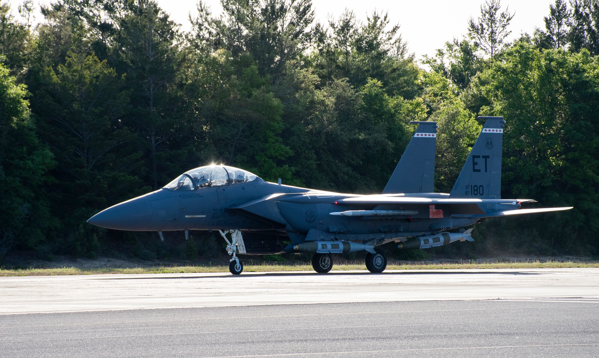 An F-15E Strike Eagle equipped with modified 2,000-pound GBU-31 Joint Direct Attack Munitions prepares for takeoff from Eglin Air Force Base, Fla., April 28, 2022, for the second test in the QUICKSINK Joint Capability Technology Demonstration. Developed by scientists and engineers from the Air Force Research Laboratory, or AFRL, this new low-cost, air-delivered capability successfully destroyed a full-scale surface vessel in the Gulf of Mexico. The test succeeded through a collaborative effort with AFRL and Eglin’s Integrated Test Team. (U.S. Air Force photo / 1st Lt Lindsey Heflin)
