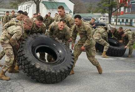 Soldiers and Airmen work together to flip tires during Pennsylvania National Guard Ranger and Sapper Assessment Program on April 21, 2022 at Fort Indiantown Gap, Pa. The troops volunteered to attend the difficult RSAP course to start the process of attending Ranger and Sapper Schools.