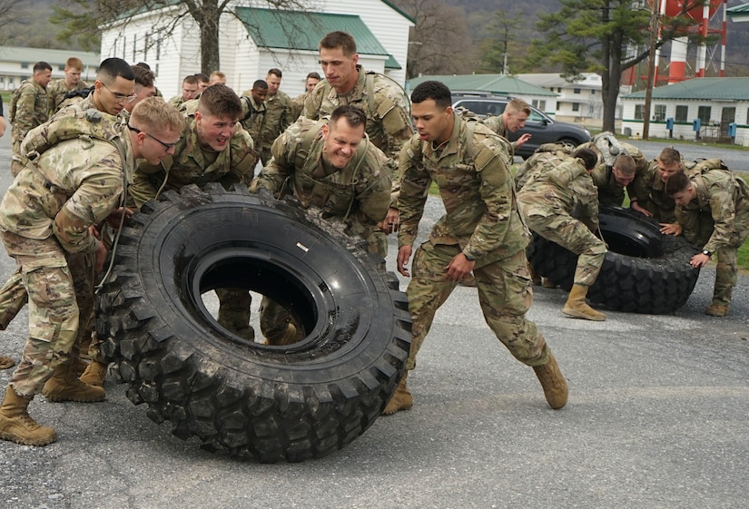Soldiers and Airmen work together to flip tires during Pennsylvania National Guard Ranger and Sapper Assessment Program on April 21, 2022 at Fort Indiantown Gap, Pa. The troops volunteered to attend the difficult RSAP course to start the process of attending Ranger and Sapper Schools.