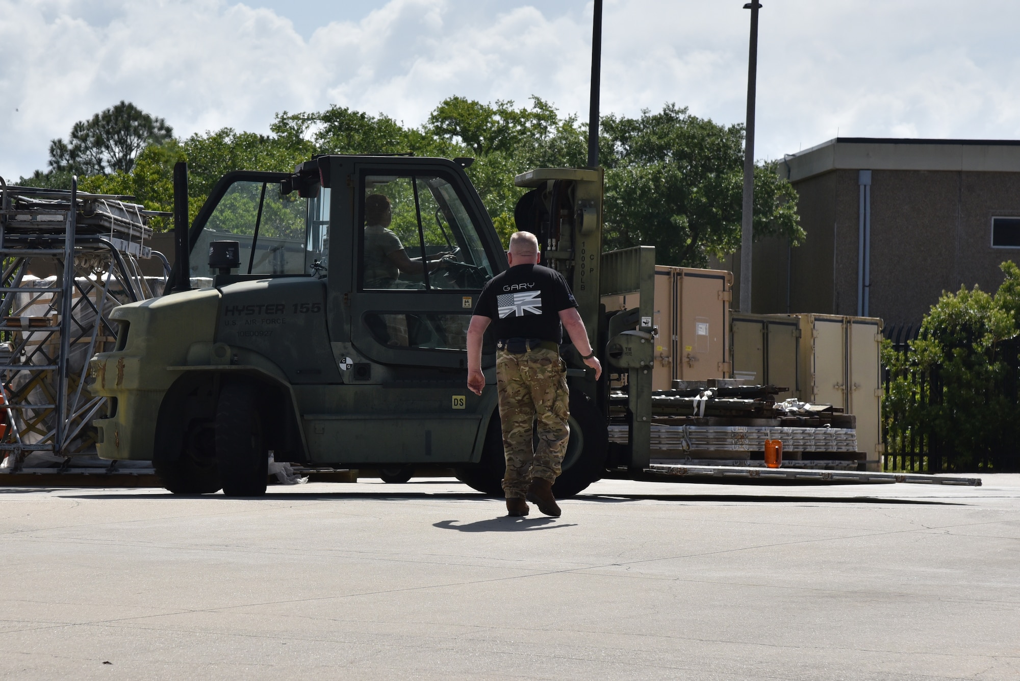 10K standard forklift driven by through cones by Air Force Reserve member being spotted by British Royal Air Force Reserve member.