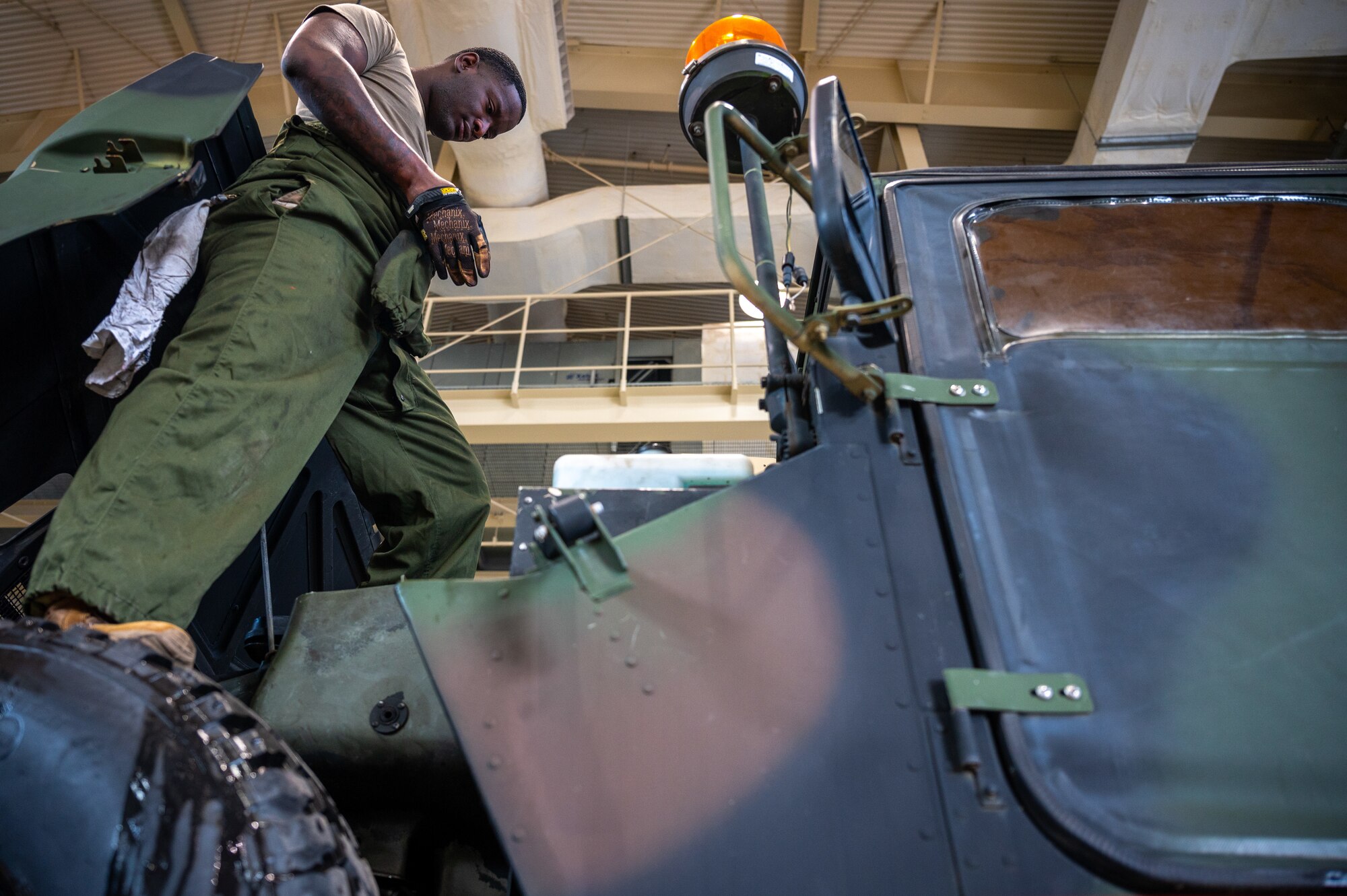 U.S. Army Specialist Darius Sims, 35th Air Defense Artillery Brigade all-wheel mechanic, inspects a high mobility multipurpose wheeled vehicle (HMMWV) at Osan Air Base, Republic of Korea, April 29, 2022.