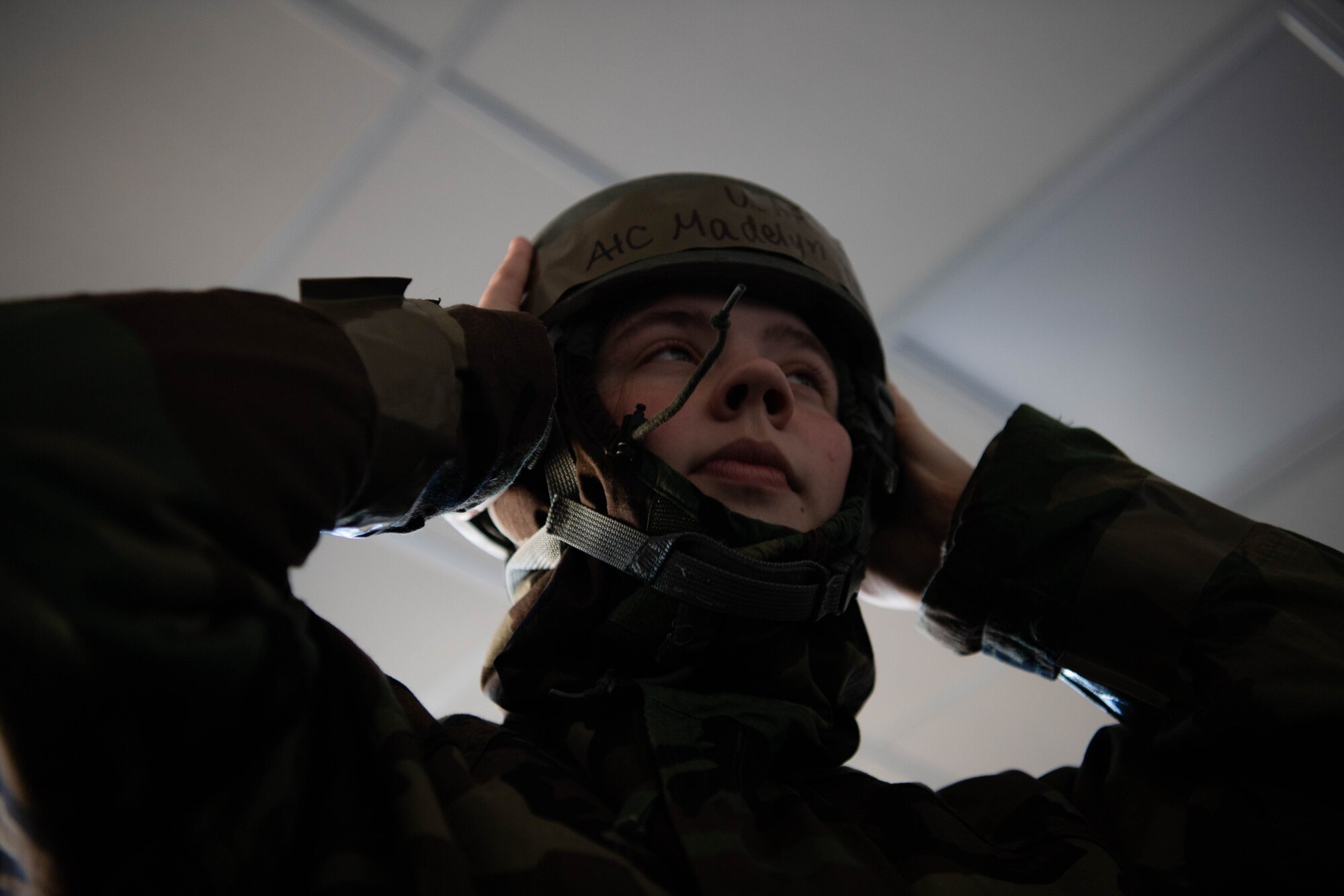 Airman puts on helmet.