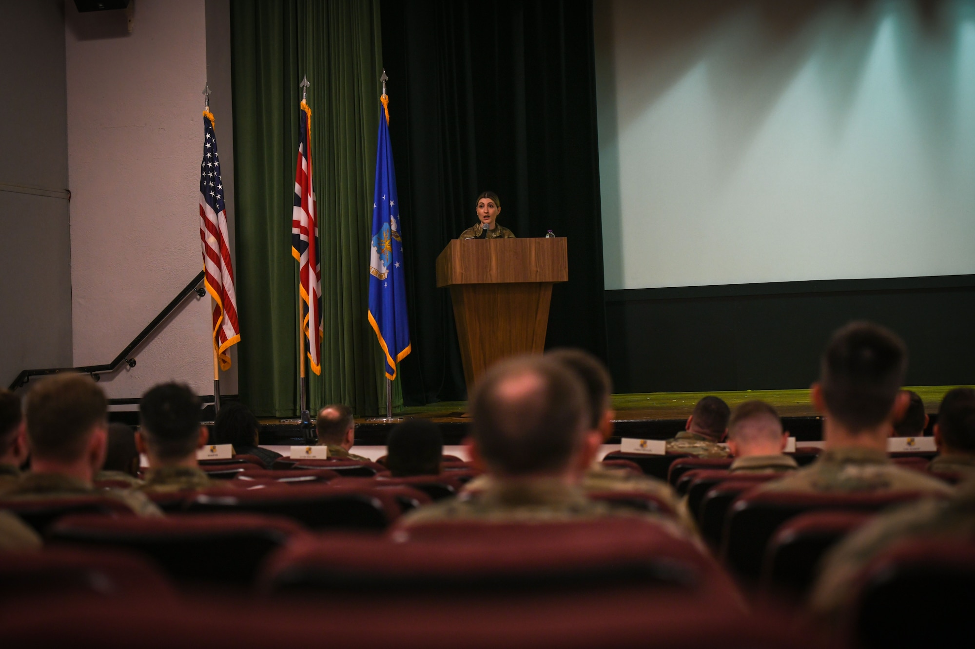 Airman speaks to audience members.