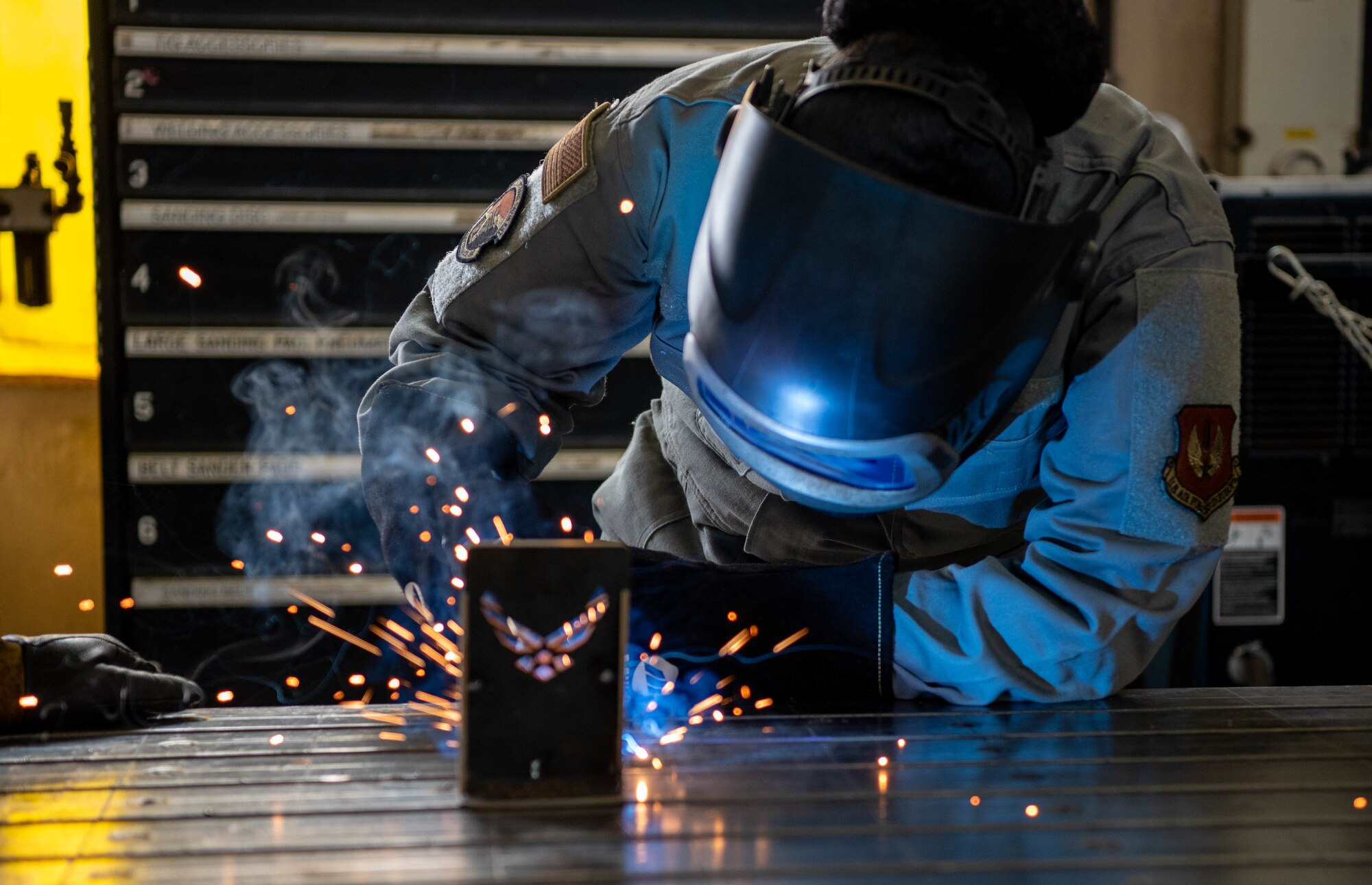 Female U.S. Air Force personnel welds