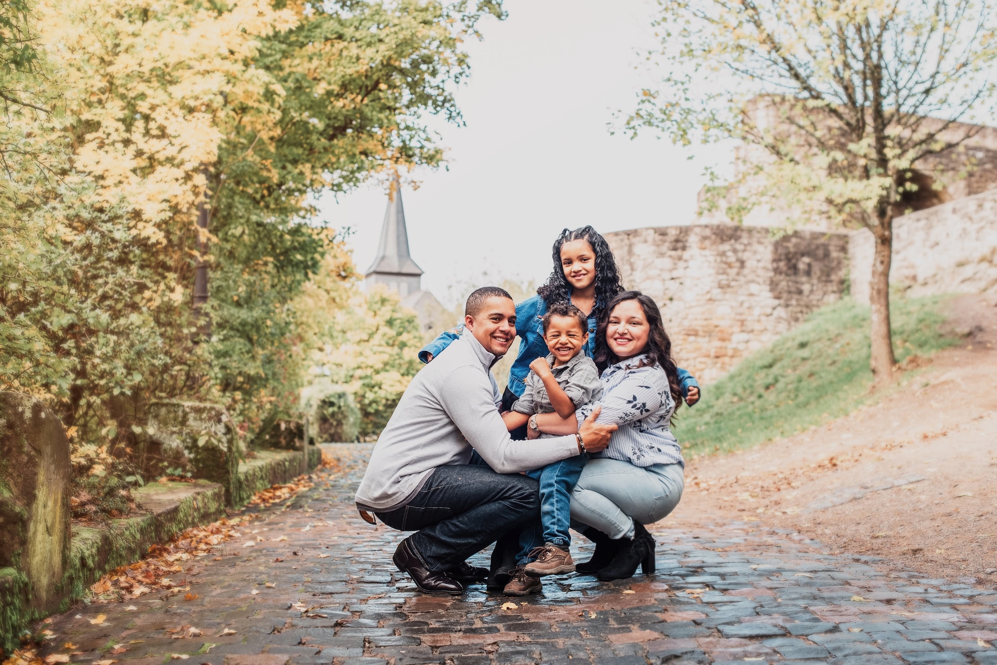 Family of four poses outside for a photo