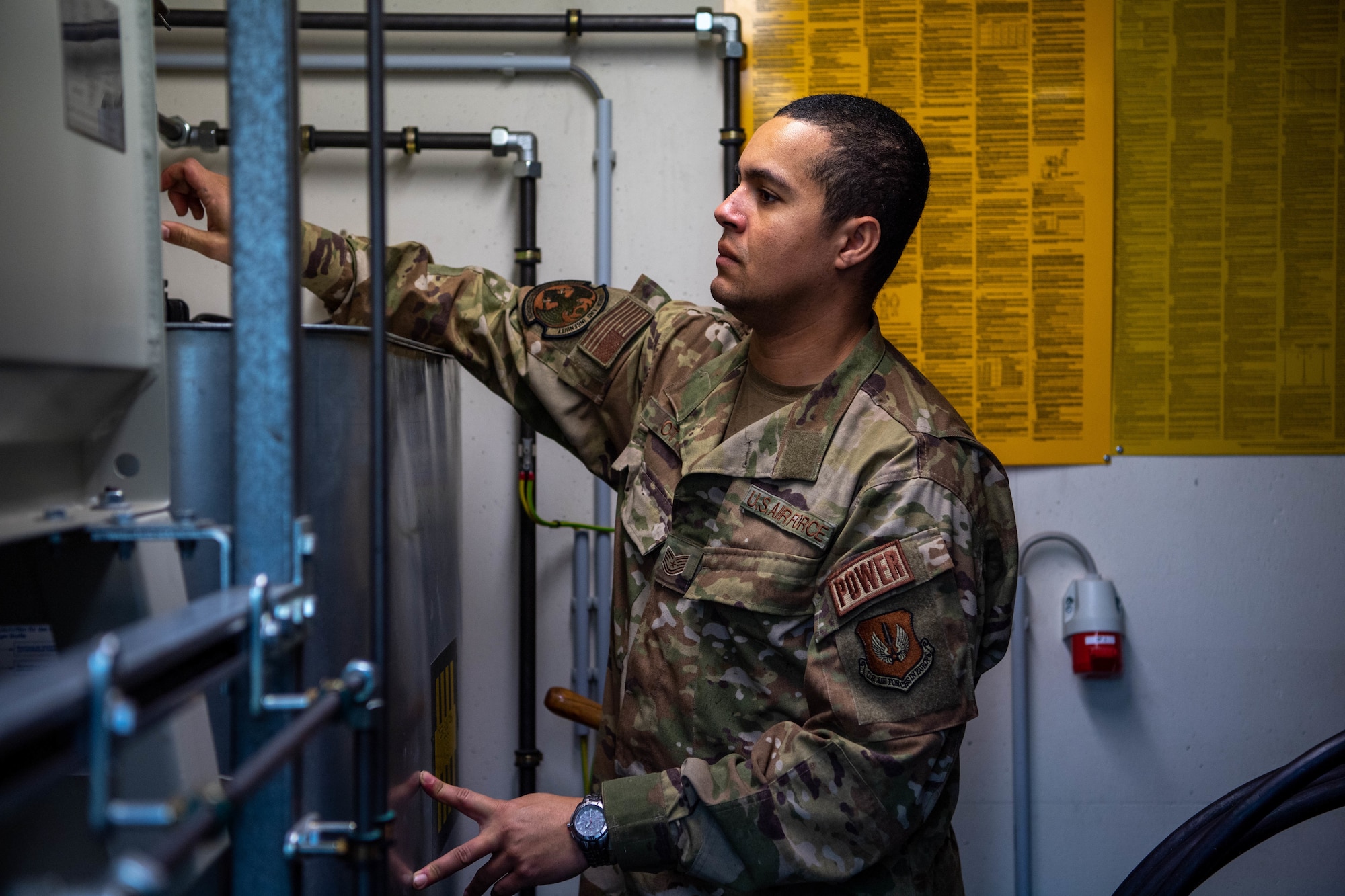 U.S. Air Force Airman inspects generator