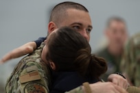 A Vermont Air National Guard member says goodbye prior to his departure from the Vermont Air National Guard Base, South Burlington, Vermont, Thursday, April 28th, 2022. The ceremony recognizes the sacrifices of Airmen and their families ahead of the 158th fighter wing’s deployment to Europe. (U.S. Air Force photo by Tech. Sgt. Richard Mekkri)