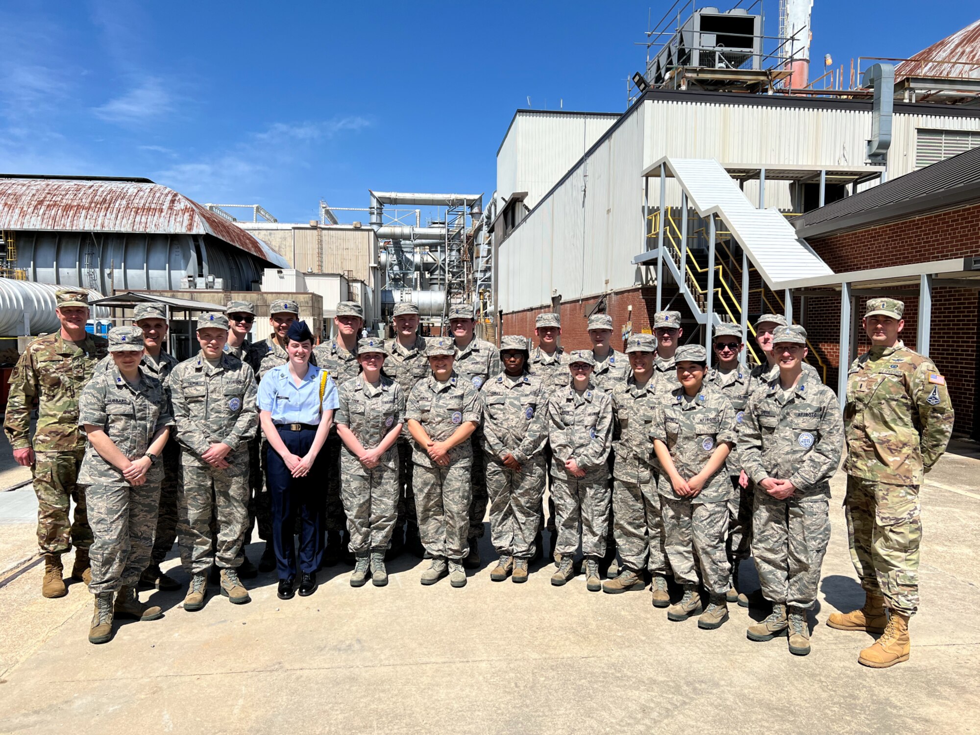 Cadets from the Air Force Junior ROTC and Space Force Junior ROTC programs at Huntsville High School in Huntsville, Alabama, pause for a photo during their visit at Arnold Air Force Base, Tenn., headquarters of Arnold Engineering Development Complex, April 13, 2022. Pictured with the cadets are, at left, Col. Carl Ise, Individual Mobilization Augmentee to the AEDC commander, and, at right, 1st Lt. Michael Hareld, a U.S. Space Force guardian and program manager for the AEDC Hypersonic Systems Test Branch. (Courtesy photo)