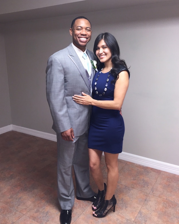 An Air Force couple in civilian clothes smiles for a photo.