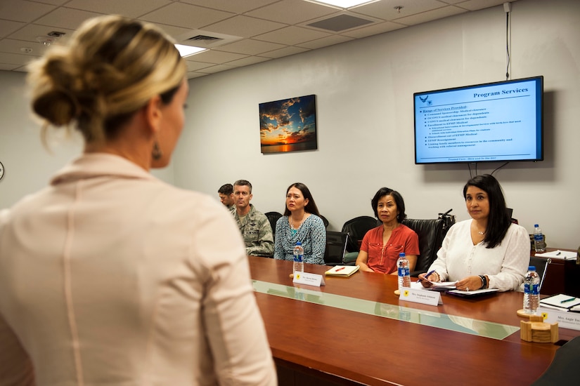 Spouses sit in a classroom.