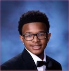 A young man poses in jacket and bow tie.