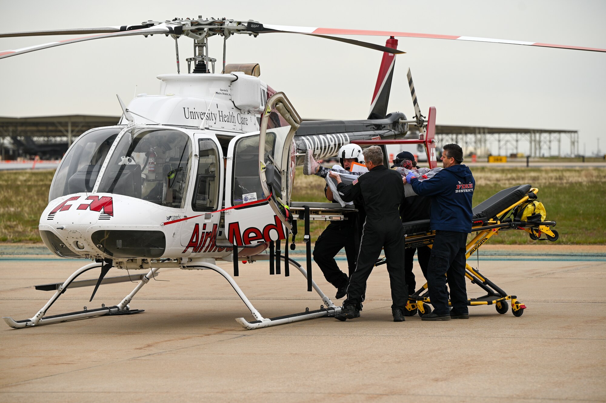 A volunteer with simulated injuries is loaded onto a helicopter by a flight crew during a crash exercise at Hill Air Force Base, Utah, April 27, 2022.