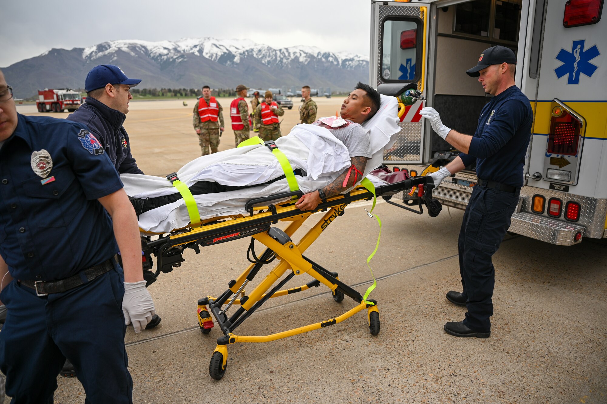 On-base and off-base medical and emergency responders render aid to simulated casualties during a crash exercise at Hill Air Force Base, Utah, April 27, 2022.