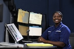 Petty Officer 1st Class Lecia Mauge-Chan, an operations specialist, poses for an environmental portrait in the command center of Coast Guard Sector Hampton Roads in Portsmouth, Virginia, March 20, 2019. Operations specialist is one of four critical ratings in Coast Guard recruiting efforts. U.S. Coast Guard photo by Matt Sprague.