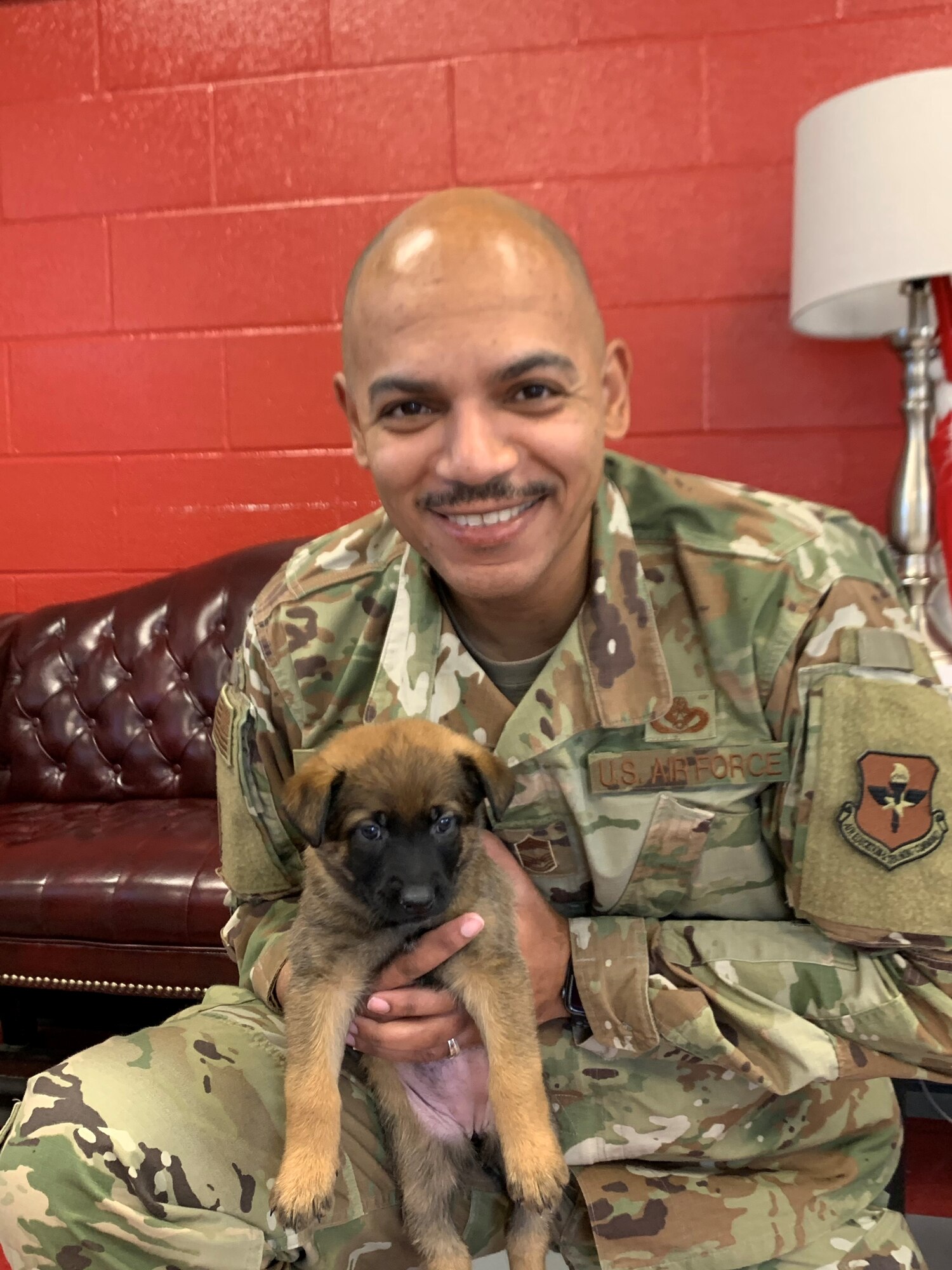CMSgt Gravely holds an MWD puppy