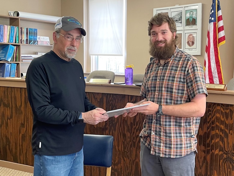 Ryan Wigner (Right), technical lead for the U.S. Army Corps of Engineers Nashville District, presents the completed Floodplain Management Services Study for Cumberland Gap, Tennessee, to Mayor Neal Pucciarelli at the city courthouse April 7, 2022. (USACE Photo by Aras Barzanji)