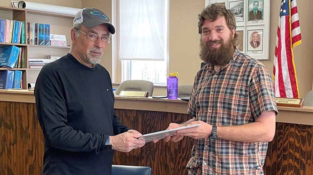 Ryan Wigner (Right), technical lead for the U.S. Army Corps of Engineers Nashville District, presents the completed Floodplain Management Services Study for Cumberland Gap, Tennessee, to Mayor Neal Pucciarelli at the city courthouse April 7, 2022. (USACE Photo by Aras Barzanji)