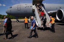 Civic leaders walk down the stairs of a KC-46A Pegasus aircraft at Duke Field flight line