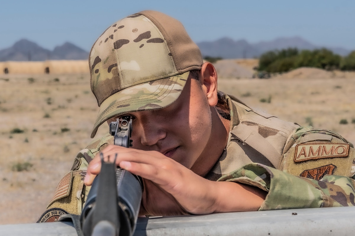 A photo of an Airman holding a gun.