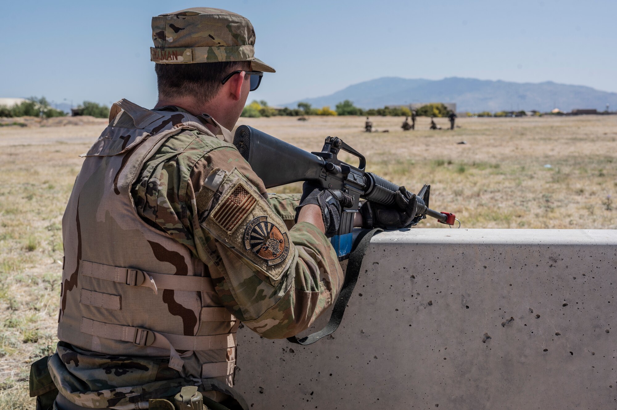 A photo of an Airman holding a gun.