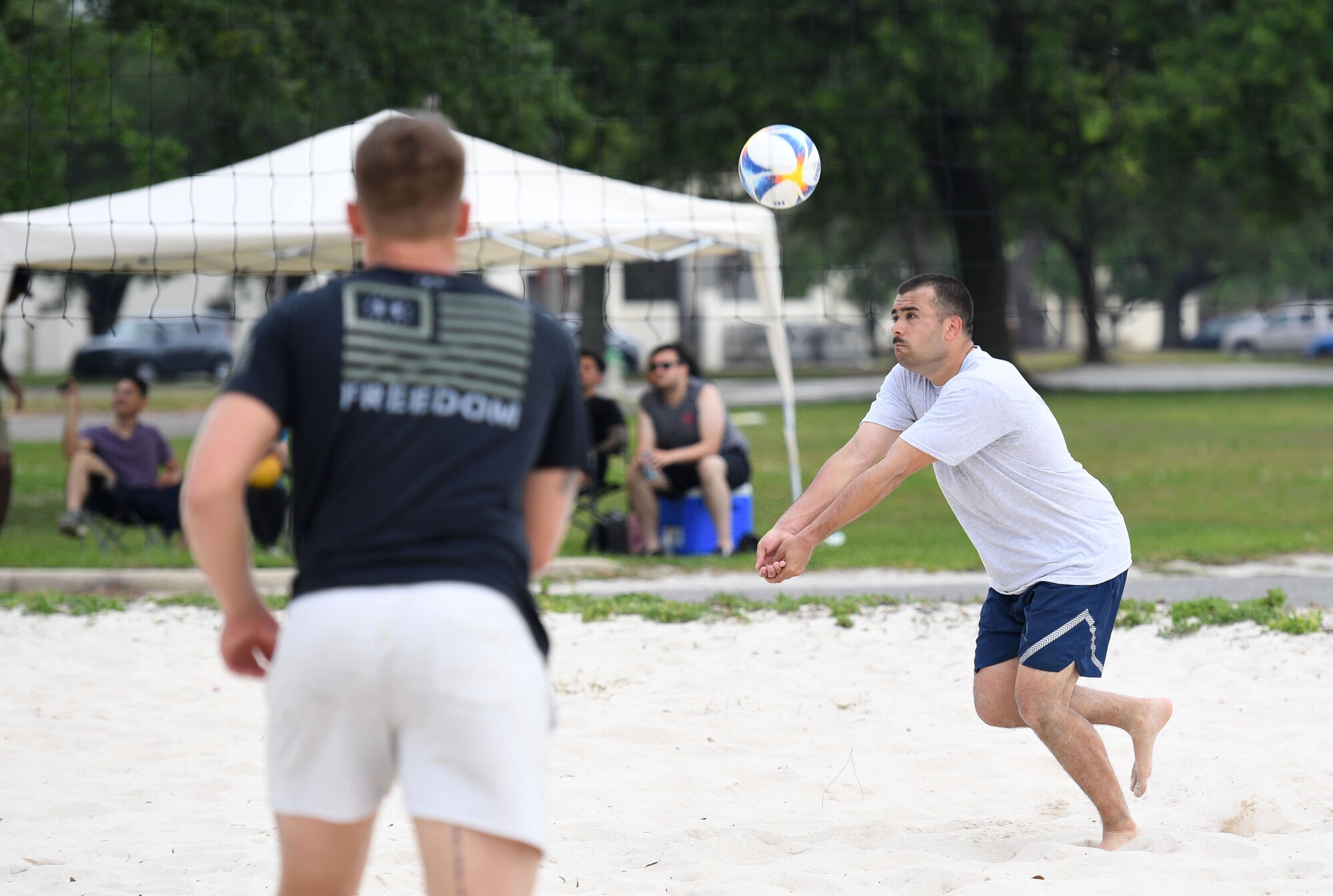 U.S. Air Force Airman 1st Class Vacchio Enzo, 338th Training Squadron student, hits a volleyball during the Sexual Assault and Awareness Prevention Month volleyball tournament at Keesler Air Force Base, Mississippi, April 29, 2022. More than 20 teams competed in the event, which was held in acknowledgment of Sexual Assault and Awareness Prevention Month throughout April. (U.S. Air Force photo by Kemberly Groue)