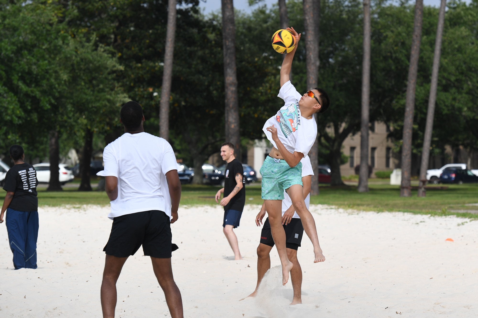 U.S. Air Force Airman Andre Phamhoang, 336th Training Squadron student, hits a volleyball during the Sexual Assault and Awareness Prevention Month volleyball tournament at Keesler Air Force Base, Mississippi, April 29, 2022. More than 20 teams competed in the event, which was held in acknowledgment of Sexual Assault and Awareness Prevention Month throughout April. (U.S. Air Force photo by Kemberly Groue)